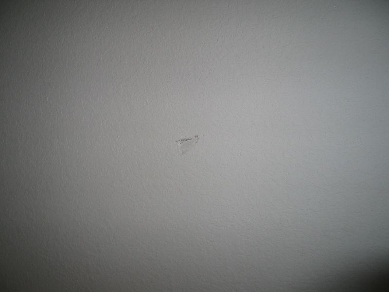 small ding in the wall near door to upstairs front bedroom