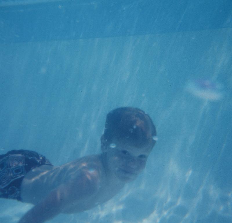 Dad had an underwater housing for his camera - Steve swimming 
