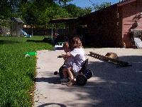 two girls on a tricycle