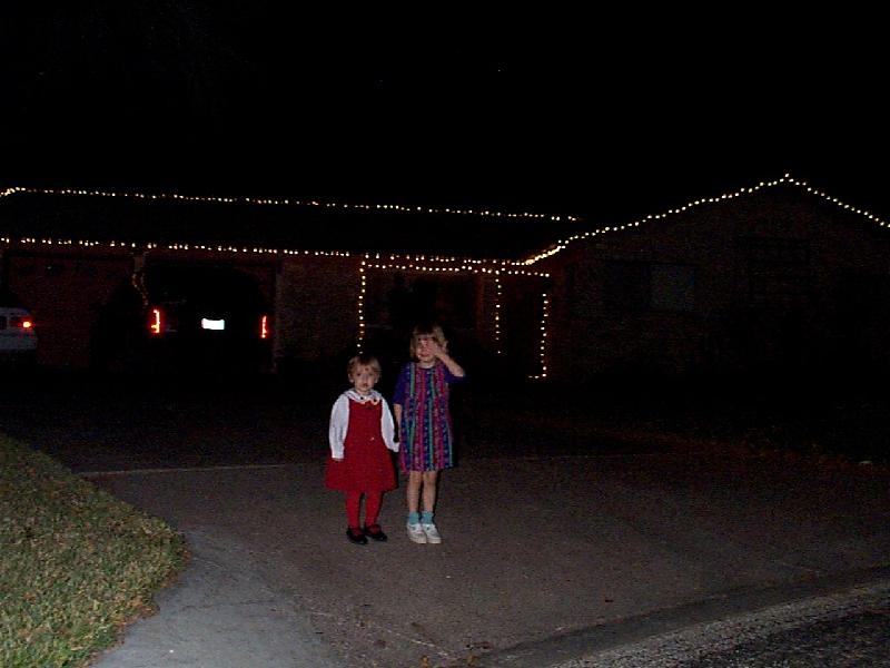 Jordan and Jada in front of the house with lights