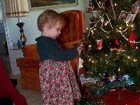 Jada hanging her ornament on the tree