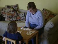 Mama and Jordan playing dominoes