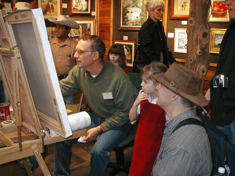 Jordan watching a man do an oil painting
