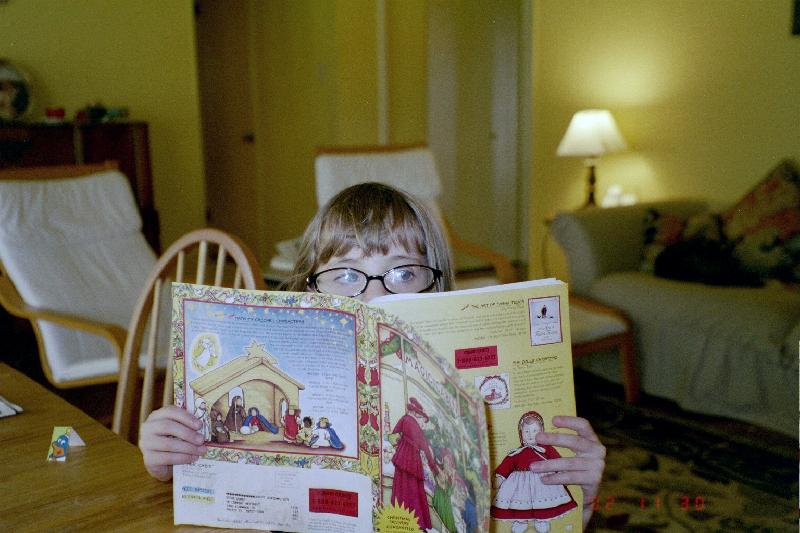 Jordan perusing a catalog while wearing some temporary glasses of Mama's