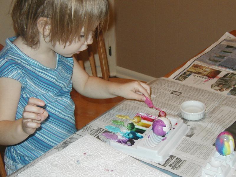 Jada roll-coloring an egg