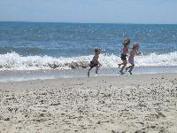 At the beach - kids running from the waves