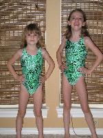 Girls showing off their new swim team swim suits!