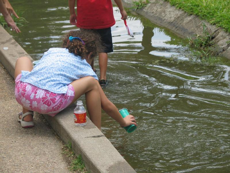 Kids capturing tadpoles