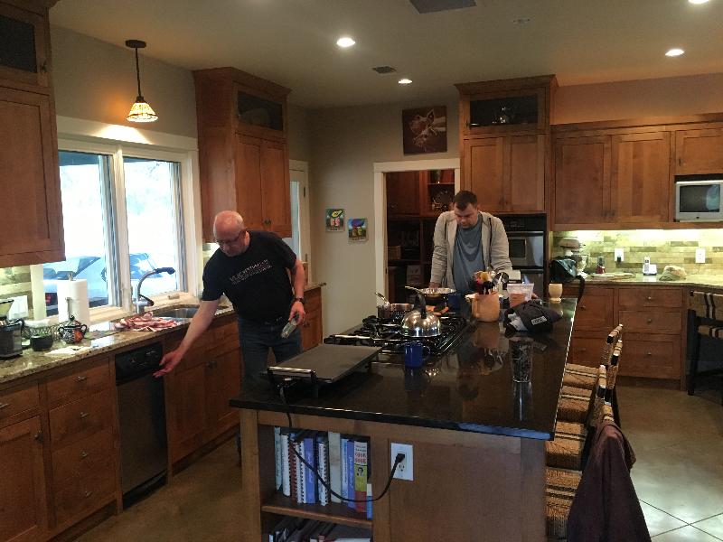 Charles getting ready to make breakfast, while Taras looks on. 
