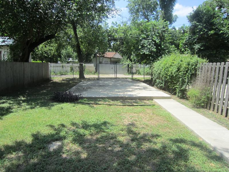 Backyard with parking pad, access via alley between 3rd St and 2nd St. 