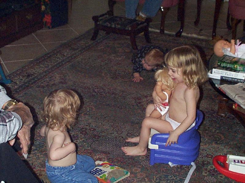 Funny Girls carrying around their booster seats