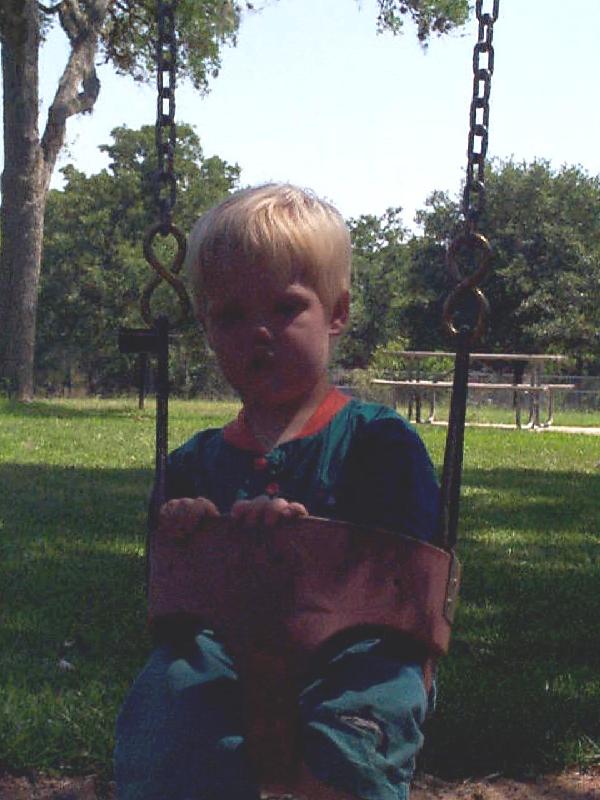 Mason got so tired, he fell asleep in the swing
