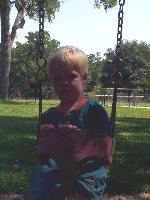 Mason got so tired, he fell asleep in the swing