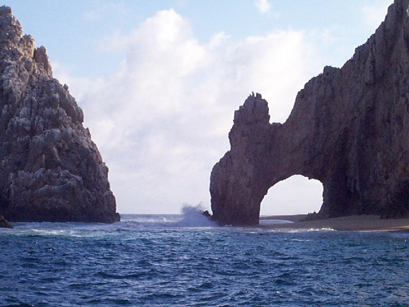 The Arch with a wave splashing up