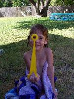 Jordan peeking through a bubble wand