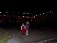 Jordan and Jada in front of the house with lights