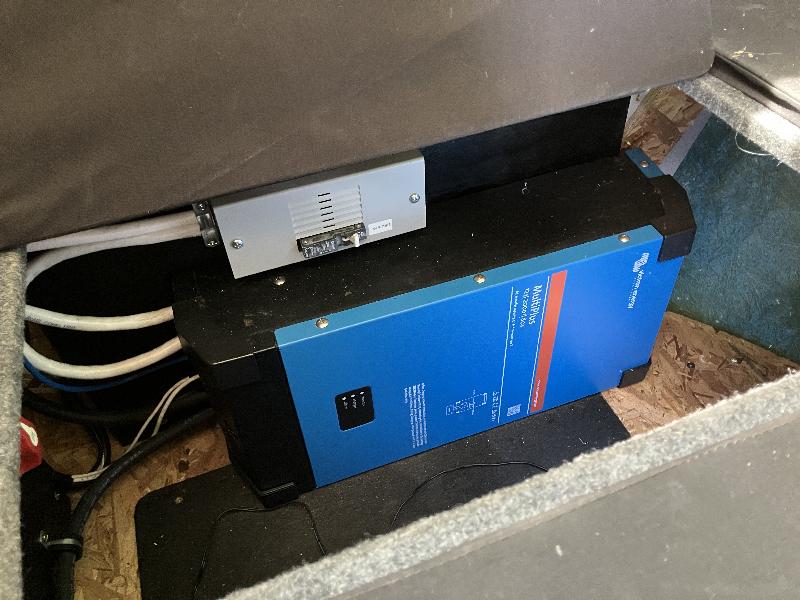 Under the driver side dinette seat - an inverter that allows the upgraded LiIon batteries to power 110V AC outlets.