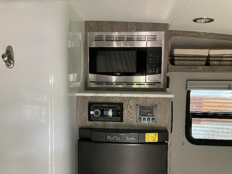 Refrigerator (three way - powered by propane, DC, or AC) <br/>Microwave <br/>Stereo<br/>Original control center