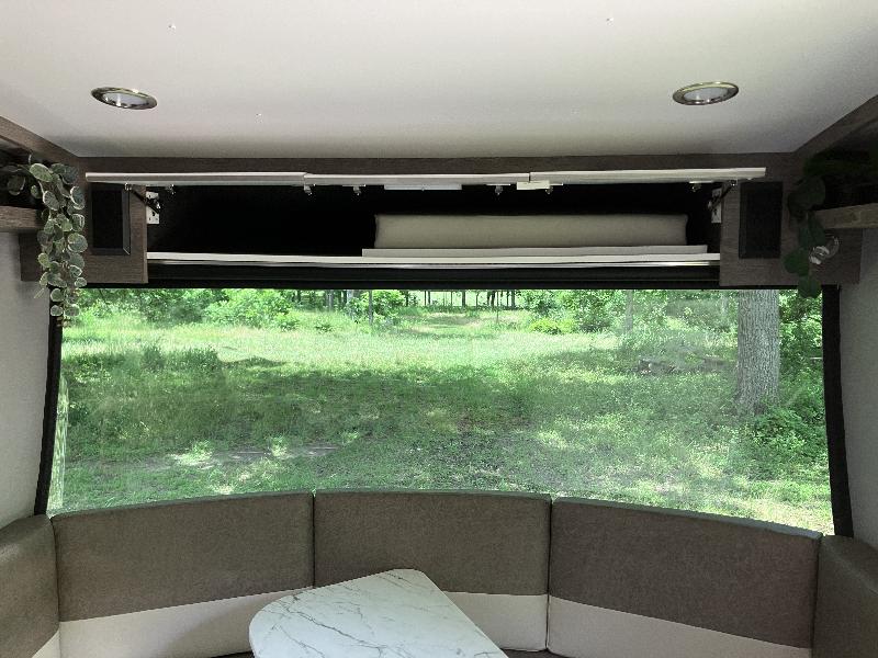 Above dinette storage, where the cushion that converts the dinette to a bed is stored. This also shows the great view out the front window. 